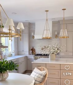 a kitchen filled with lots of white counter tops and chairs next to a dining room table