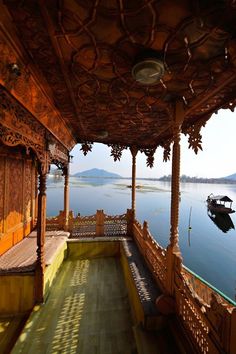 an ornate wooden porch overlooks the water