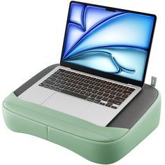 an open laptop computer sitting on top of a green case with a blue wave design