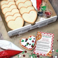 a box filled with lots of cookies and other items on top of a wooden table