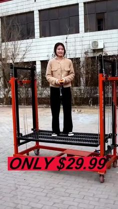 a woman standing on top of a red cart