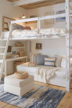 a white bunk bed sitting on top of a wooden floor next to a blue rug