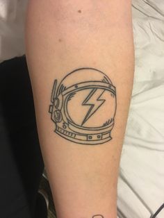 a tattoo on the arm of a person with a helmet and lightning bolt in it