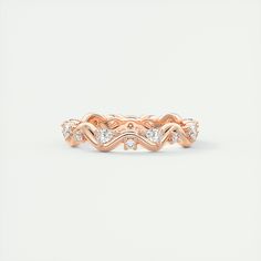 a rose gold wedding band with three diamonds on the top and bottom, set in 18k pink gold