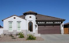 a white house with brown doors and windows