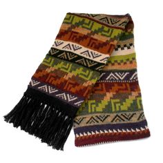 "Enhance your winter style with our Andean-inspired wool scarf, featuring vibrant multicolored patterns. Crafted in Peru from a blend of Alpaca, Sheep, and Acrylic, this unique accessory effortlessly blends comfort and cultural flair. Whether for yourself or as a distinctive gift, it's a celebration of Andean craftsmanship in every thread. Product Details Material: 40% Alpaca / 10% Sheep / 50% Acrylic Color: Multicolored Measurement: 70\"L x 8\"W, Fringe 4\" Weight: 0.71 lb Thickness: Thick Weight Style: Andean design Care: Hand Wash/Dry Flat Made in Peru Alpaca Alpaca, Luxury Andean Treasure: The alpaca is member of the South American camel family, which is closely related to the llama, the guanaco, and the vicuña. Alpaca wool was used by pre-Inca and Inca cultures to create extraordinary Multicolor Alpaca Shawl, Traditional Multicolor Fringed Scarves, Multicolor Fringe Scarf One Size, Handwoven Alpaca Winter Scarf, Cozy Hand-knitted Alpaca Scarves, Alpaca Scarf, Alpaca Fiber, Knit Alpaca, Black Fringe