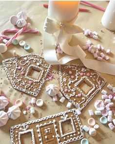 gingerbread cutouts are laying on a table with ribbons and confetti scattered around them