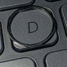 a close up of a computer keyboard with the letter d on it's side