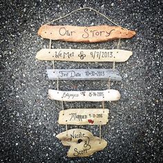 some wooden signs hanging on the side of a road with names and dates attached to them