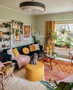 a living room filled with furniture and lots of plants