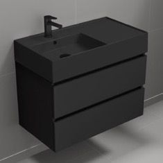 a black sink sitting next to a wall mounted faucet