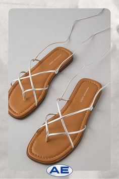 Vegan leather upper/Thong construction/Lace-up closure/Rubber outsole Casual Synthetic Toe Post Lace-up Sandals, Flat Heel Lace-up Synthetic Sandals With Removable Insole, Lace-up Sandals With Cushioned Footbed For Vacation, Vacation Lace-up Sandals With Cushioned Footbed, Trendy Strappy Leather Lace-up Sandals, Adjustable Flat Lace-up Sandals With Removable Insole, Lace-up Sandals With Removable Insole, White Jeans Men, Aerie Bras