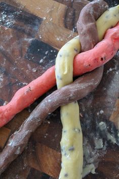 a piece of food that is on top of a cutting board with some kind of chain