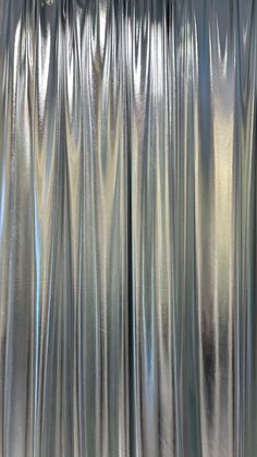 an image of a curtain that is shiny and silver in the day light or night