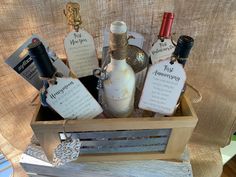 a wooden crate filled with wine bottles on top of a table covered in burlap