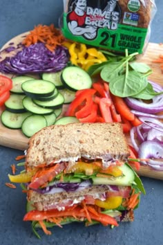 a sandwich with lettuce, carrots, cucumbers and other vegetables