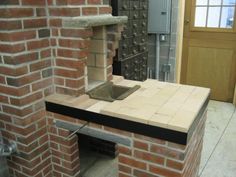 a brick oven sitting inside of a kitchen