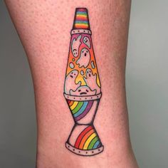 a woman's leg with a colorful tattoo on it