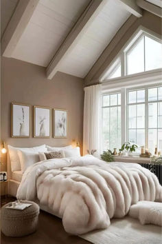 a bedroom with a large bed covered in white fur