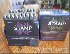 two boxes of stamp punch set sitting on a table