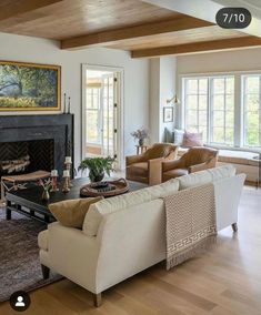 a living room filled with furniture and a fire place in the middle of a room