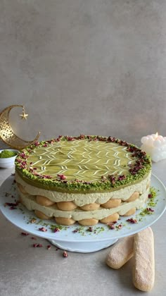 a cake with green frosting on a plate next to some cookies and other items