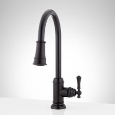 a black faucet on a white counter top with the handles turned to look like an old fashioned kitchen faucet