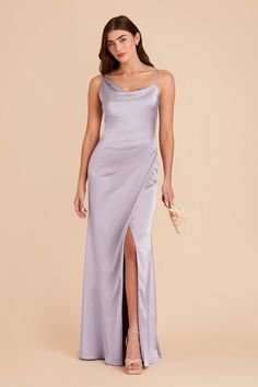 a woman in a long purple dress with a slited skirt and one side slit