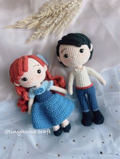 two crocheted dolls standing next to each other