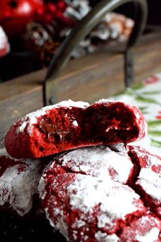 red velvet crinkle cookies are piled on top of each other with powdered sugar