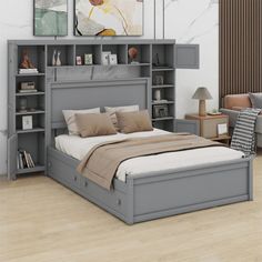 a bedroom with a bed, bookcases and two couches in the background