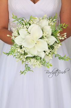 a woman in a white dress holding a bouquet of flowers