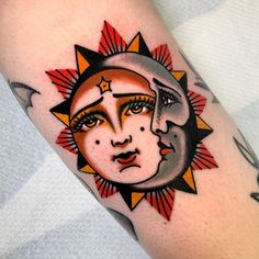 a sun and moon tattoo on the left arm, with an orange star in the center