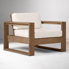 a wooden chair with white upholstered cushions