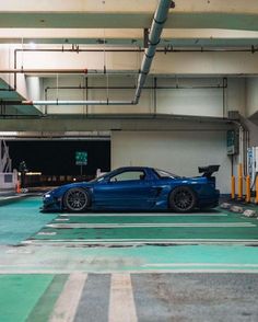 a blue sports car parked in a parking garage