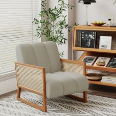 a chair sitting in front of a book shelf with books on top of it next to a window