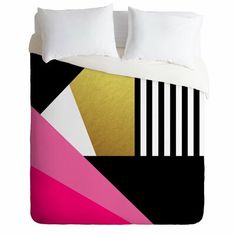 a bed with black, white and pink comforter covers on top of each other