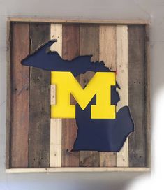 the michigan state is made out of pallet wood and painted with blue and yellow