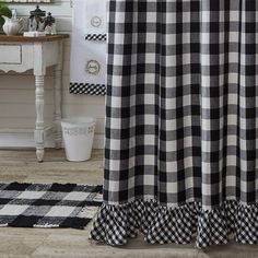 a black and white checkered shower curtain with ruffles on the bottom is shown