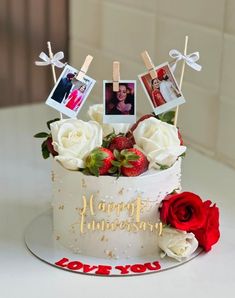 a birthday cake decorated with photos and strawberries