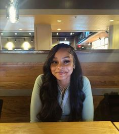 a woman sitting at a table with food in front of her