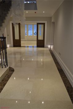 an empty room with stairs and lights on the floor in front of a door that leads to another room