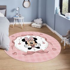 a pink minnie mouse rug in a child's bedroom