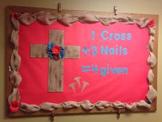 a bulletin board that has been decorated with flowers and the words cross, nails, and given on it