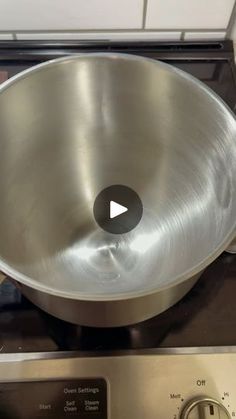 a metal bowl sitting on top of an oven