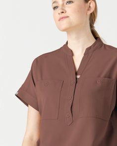 Loose, oversized sleeves that fall over the shoulder and button pocket details, our Fiji top has it all. Designed with intentionality for style and comfort. - Oversized fit - Mandarin collar style - Two front chest pockets - Button detailing - Signature 3 stripe detailing on the collar - Back box pleat Oversized Brown Shirt For Workwear, Brown Button Closure Tops For Work, Brown Workwear Tops With Button Closure, Brown Tops With Button Closure For Work, Casual Brown Tops With Button Cuffs, V-neck Shirt With Pockets For Work, V-neck Workwear Shirt With Pockets, Casual Brown Blouse With Relaxed Fit, Versatile Batwing Sleeve Workwear Tops