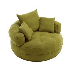 a large green chair with pillows on it