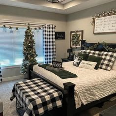 a bedroom decorated for christmas with black and white decor