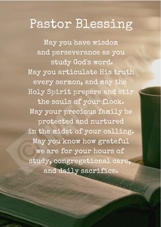 a cup of coffee sitting on top of an open book next to a candle with the words pastor blessing