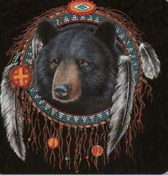 a black bear with feathers on it's head and cross in the back ground